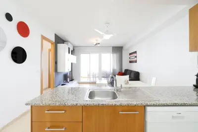 a kitchen with a sink and a counter top at Tu refugio en Canet, piscina, parking y playa in Canet de Berenguer