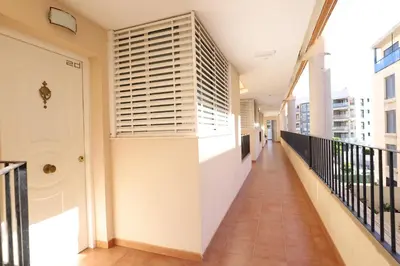 a corridor of a building with a balcony at Tu refugio en Canet, piscina, parking y playa in Canet de Berenguer