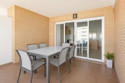a dining room with a table and chairs at Tu refugio en Canet, piscina, parking y playa in Canet de Berenguer