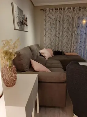 a living room with a brown couch and a table at Exclusivo apartamento en Canet in Canet de Berenguer