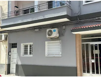 a gray building with a air conditioner on a balcony at Apartamento tipo loft valencia in Paiporta