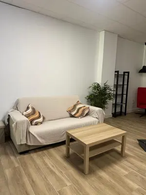a living room with a couch and a coffee table at Apartamento tipo loft valencia in Paiporta