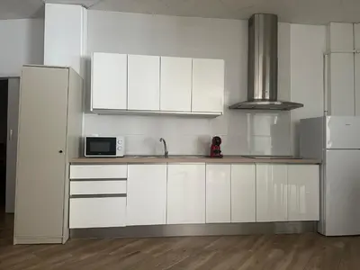 a kitchen with white cabinets and a microwave at Apartamento tipo loft valencia in Paiporta
