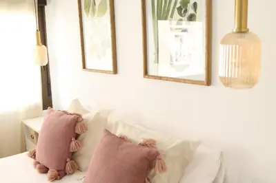 a bedroom with two pink pillows on a bed at FLORIT FLATS - The Apolo Apartment in Valencia