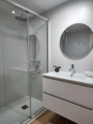 a white bathroom with a sink and a mirror at FLORIT FLATS - The Apolo Apartment in Valencia