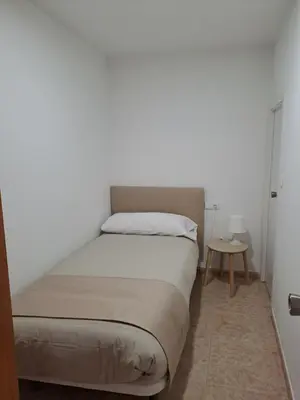 a kitchen with a white refrigerator and a microwave at Habitación familiar Portalet in Benaguacil