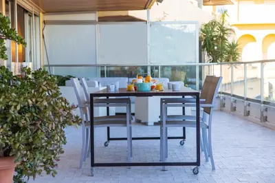 a table and chairs sitting on a balcony at Cullera Beach Apartment Cap Blanc in Cullera