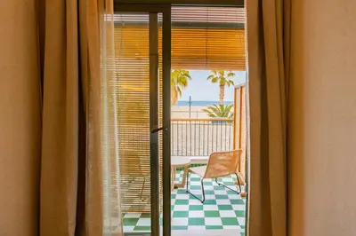 a room with a view of the ocean from a balcony at Casa Bassa Hotel in Valencia