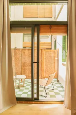 a room with a sliding glass door with a chair at Casa Bassa Hotel in Valencia