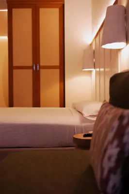 a hotel room with two beds and a closet at Casa Bassa Hotel in Valencia