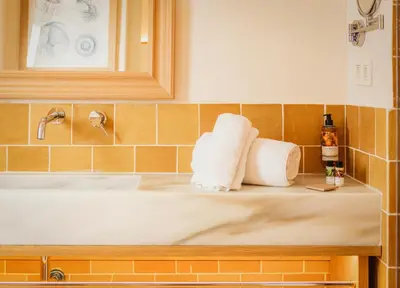 a bathroom with two towels sitting on a sink at Casa Bassa Hotel in Valencia