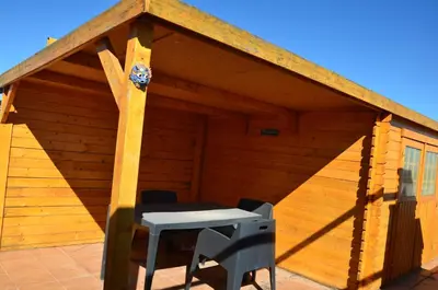 a wooden shed with a table and chairs in it at FeWo - Moncofa Apartment in Moncófar