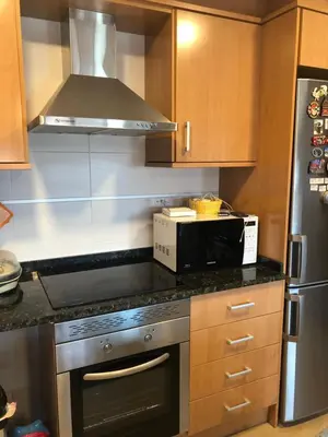 a kitchen with a stove and a microwave at FeWo - Moncofa Apartment in Moncófar