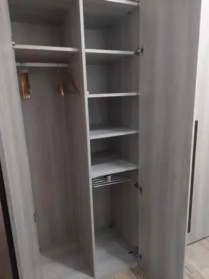 a closet with white shelves in a room at Family Apartment Andrea in Alaquas