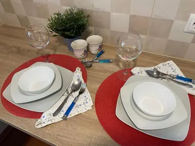 a table with two plates and wine glasses on it at Habitaciones con cocina y baño privado de temporada Vacaciones largas Long Stay desde 11 noches in Valencia