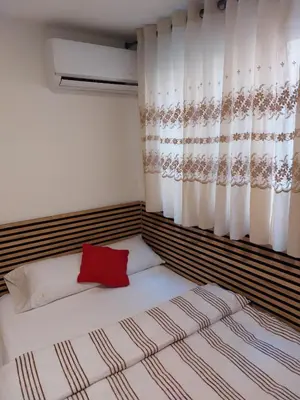 a bedroom with a bed with a red pillow at Habitaciones con cocina y baño privado de temporada Vacaciones largas Long Stay desde 11 noches in Valencia