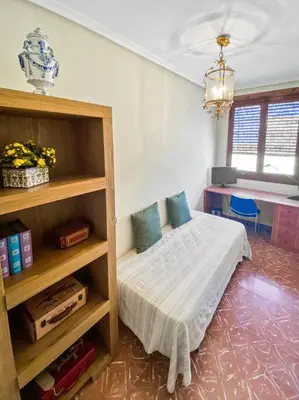 a bedroom with a bed and a book shelf at Huerto Valenciano - Sol y Tranquilidad - Piscina in Valencia