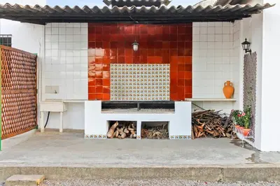a building with a fireplace in the side of it at Huerto Valenciano - Sol y Tranquilidad - Piscina in Valencia