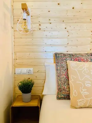 a bedroom with a bed with a wooden wall at B1 Verdeguer - Flat close to the Beach in Valencia