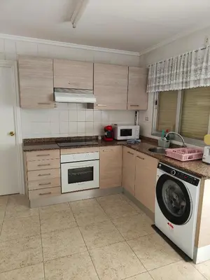 a kitchen with a washing machine and a washer at Estrella playa in Puerto de Sagunto