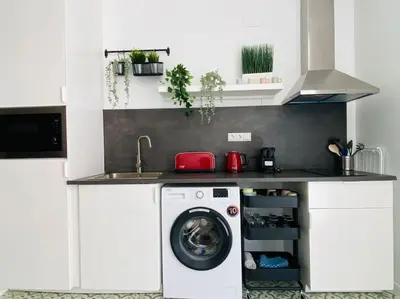 a kitchen with a washing machine under a counter at B3 Verdeguer - Cozy Loft Close to the Beach in Valencia