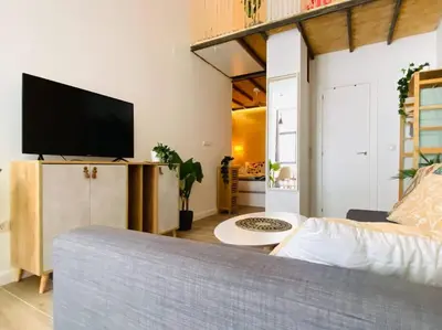 a living room with a couch and a flat screen tv at B3 Verdeguer - Cozy Loft Close to the Beach in Valencia