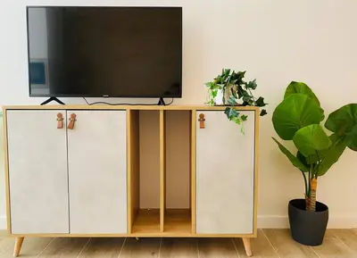 a television on top of a cabinet in a living room at B3 Verdeguer - Cozy Loft Close to the Beach in Valencia