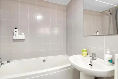 a bathroom with a white tub and a sink and a bath tubermott at Sagunto - Albalat de Tarongers - Estivella - Gilet in Albalat de Taronchers