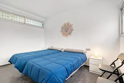 a bedroom with a large blue bed and chairs at Sagunto - Albalat de Tarongers - Estivella - Gilet in Albalat de Taronchers