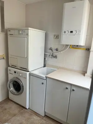 a kitchen with a washing machine and a washer at FRENTE AL MAR in Burriana