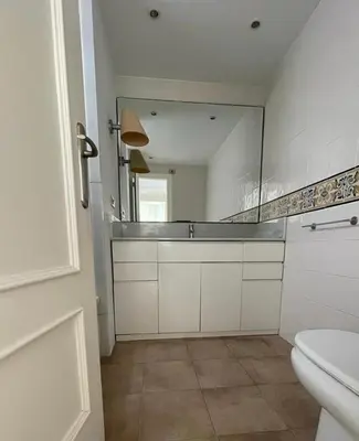 a bathroom with a mirror and a sink and a toilet at FRENTE AL MAR in Burriana