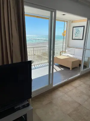 a living room with a view of the beach at FRENTE AL MAR in Burriana