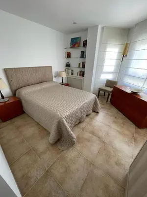 a bedroom with a bed and a desk and two windows at FRENTE AL MAR in Burriana
