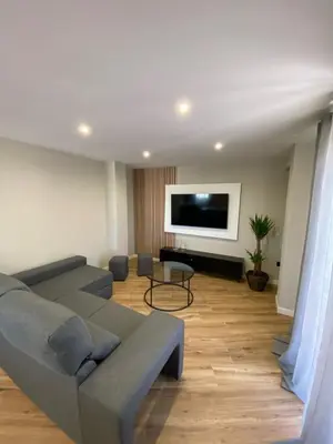 a living room with a couch and a flat screen tv at El Labrador in Anna