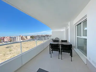 a balcony with a table and chairs and a view at Global Vacacional, Apartamento para 5 personas con terraza in Canet de Berenguer