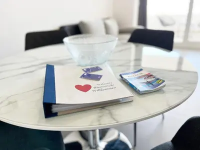 a table with a book and a wine glass on it at Global Vacacional, Apartamento para 5 personas con terraza in Canet de Berenguer