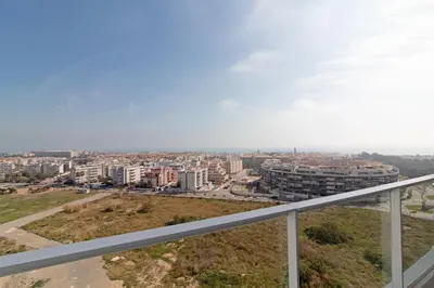 a view of a city from the balcony of a building at Global Vacacional, Apartamento con terraza y vistas a la costa mediterránea in Canet de Berenguer