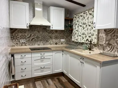 a kitchen with white cabinets and a sink at Casa en primera linea de playa in Puzol