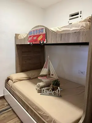 a bunk bed with a toy bus on the bottom bunk at Casa en primera linea de playa in Puzol
