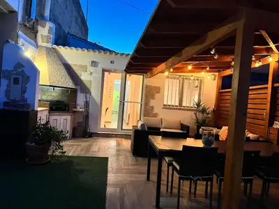 a patio with a table and chairs in a house at Casa en primera linea de playa in Puzol
