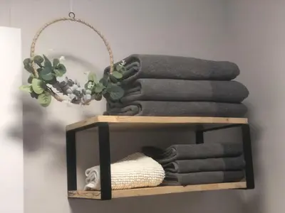 a wooden shelf with towels and a plant at Urban Beach in Valencia