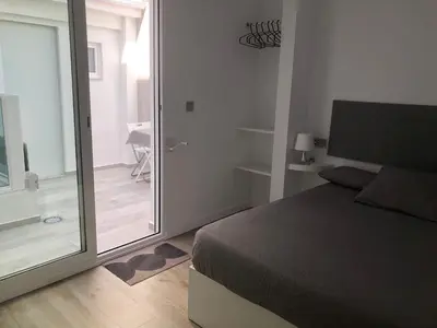 a bedroom with a bed and a sliding glass door at Urban Beach in Valencia
