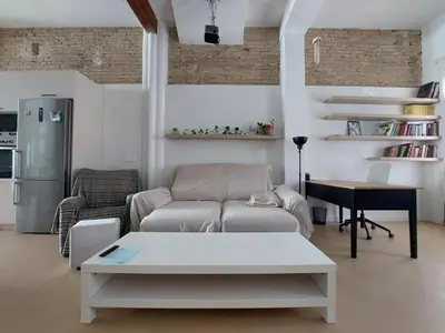 a living room with a couch and a table at Maritime House Valencia Beach in Valencia