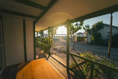 an open porch of a house with a wooden railing at HolaCamp Chilches in Xilxes