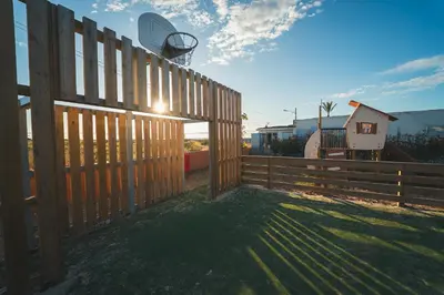 a wooden fence with a basketball hoop on top of it at HolaCamp Chilches in Xilxes
