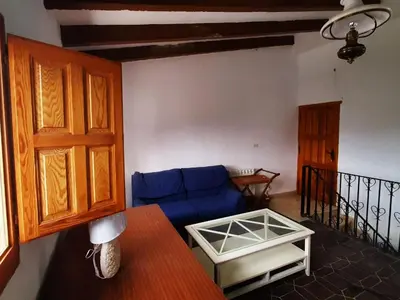a living room with a blue couch and a table at Villa near Valencia with Private Pool in Valencia