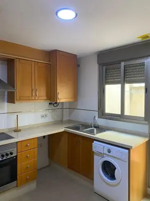 a kitchen with a sink and a washing machine at Apartamento San Vicente in Villar del Arzobispo