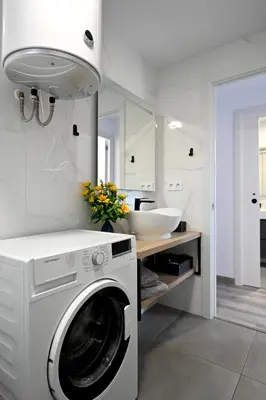 a white laundry room with a washer and a sink at Victoria Apartment in Puerto de Sagunto