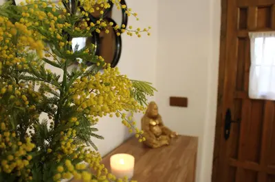 a vase with a candle on a table next to a vase at Alojamiento turistico LaVid in Requena