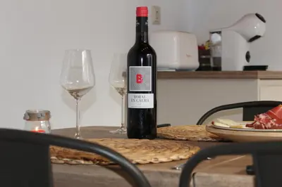 a bottle of wine sitting on a table with two glasses at Alojamiento turistico LaVid in Requena